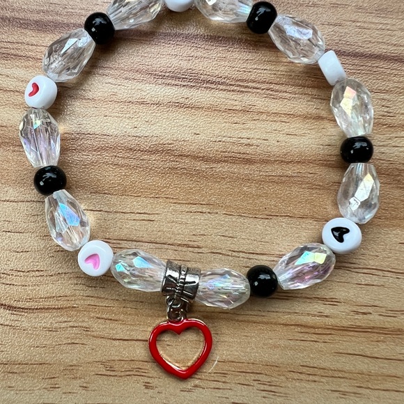 Beaded stretchy bracelet with clear acrylic beads, heart beads and charm - Picture 3 of 3